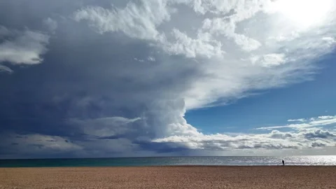One person walking on an empty spanish beach in the cloudy stormy sky, 4K Stock Footage 273171472