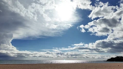One person walking on an empty spanish beach in the cloudy stormy sky, 4K Stock Footage 273171484
