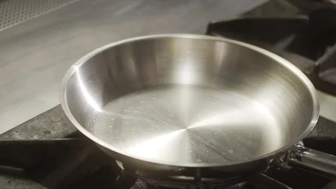 One piece of butter falls into hot pan. Slow motion video Stock Footage 124684981