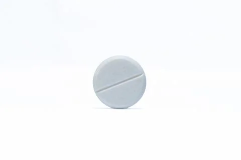 One pill on white background Stock Photos