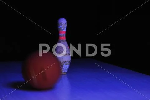 One pin with bowling ball in ultraviolet light Stock Photos