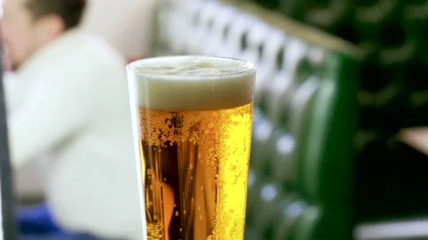 One pint of beer standing on the bar counter in a modern restaurant. 4K Stockbeeldmateriaal 91077185