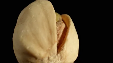 One pistachio nut on a dark background. High content of protein, fiber and Stock Footage 165025151