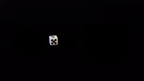 One playing white bone flies out on a black background. The cube flies, rotates Stock Footage 129870805