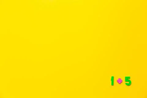 One plus five equals six is example on yellow background. Copy space. Math Stockfoto's