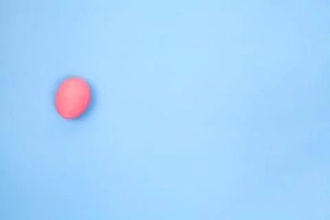 One preserved egg on blue background with space for copy. Stock Photos