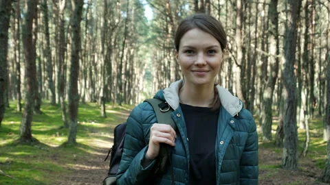 One pretty lady in jacket keep rucksack closeup with scenery background of treet Stock Footage 199492802