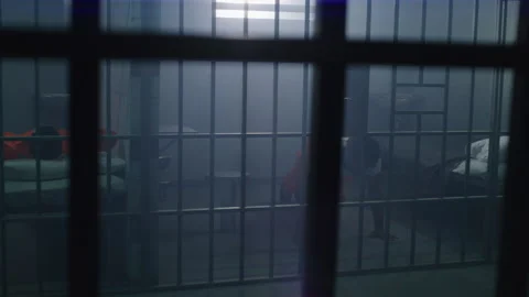 One prisoner lies on bed, another doing push-ups Stock Footage 246955028