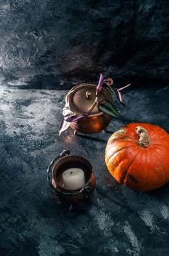 One pumpkin squash and copper or brass witch pots with candles and palo santo Stock Photos
