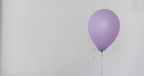 One purple balloon white wall background Stock Footage 87203777