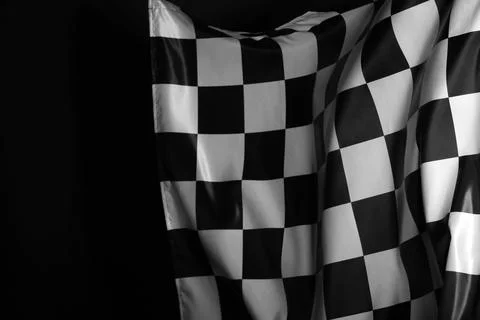 One racing checkered flag on black background, space for text Stock Photos