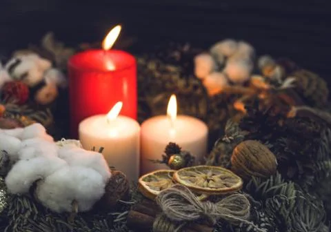 One red and two white candles in a wreath Stock Photos
