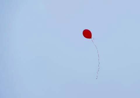 One red balloon on a string in the sky Stock Photos
