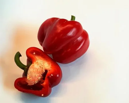 One red bell pepper of irregular round shape and half, Stock Photos