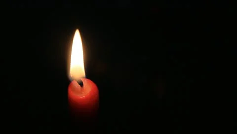 One red candle on black Stock Footage 11022341