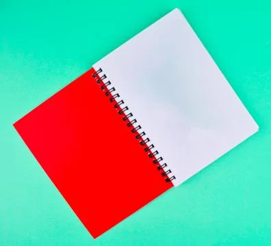 One red colored note paper diary placed on a light blue paper background Stock Photos