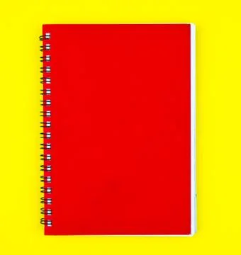 One red colored note paper diary placed on a isolated yellow background Stock Photos