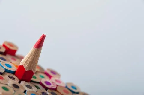 One red crayon on the background of pencils Stock Photos