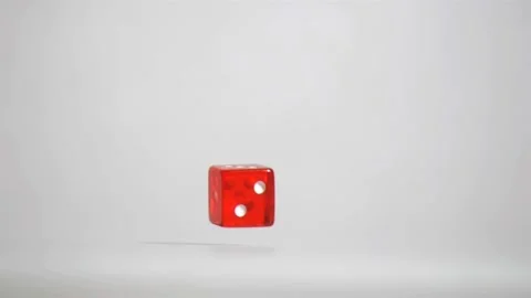 One red dice in super slow motion turning near the floor Stock Footage 219759570