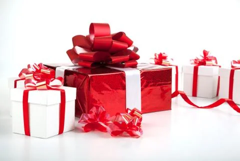 One red gift box white gift boxes on gray Stock Photos