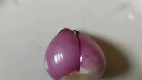 One red onion that has been peeled Stock Footage 226730425