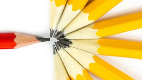 One red pencil in a circle of yellow pencils in 4K. Stock Footage 233455889