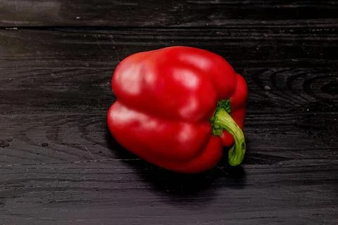 One red pepper on a black background Stock Photos
