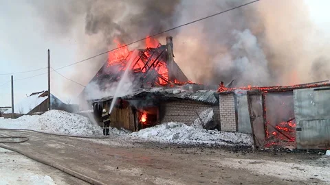 One rescuer puts out the fire in the village Stock Footage 87541246
