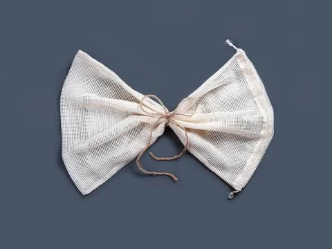 One reusable string bag folded by the rope in the form of the bow tie. Stock Photos