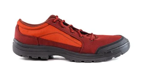One right cheap orange fabric hiking or hunting shoe isolated on white 库存照片