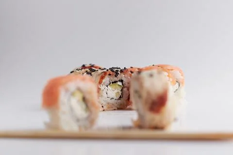 One roll in focus, a portion of rolls out of focus, Asian food, sushi and fish Stock Photos