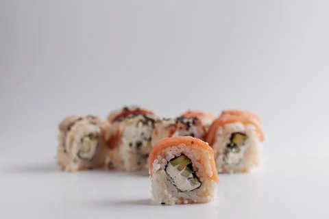 One roll in focus, a portion of rolls out of focus, Asian food, sushi and fish Stock Photos