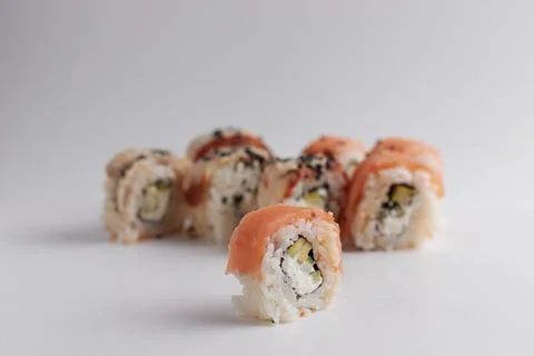 One roll in focus, a portion of rolls out of focus, Asian food, sushi and fish Stock Photos