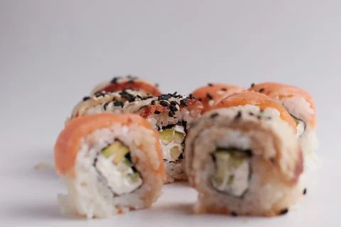 One roll in focus, a portion of rolls out of focus, Asian food, sushi and fish Stock Photos