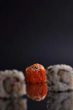 One roll in focus, a portion of rolls out of focus, Asian food, sushi and fish Stock Photos
