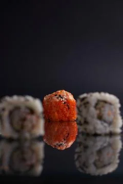 One roll in focus, a portion of rolls out of focus, Asian food, sushi and fish Stock Photos