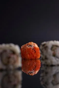 One roll in focus, a portion of rolls out of focus, Asian food, sushi and fish Stock Photos