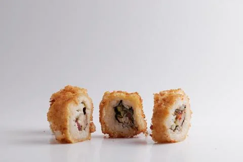 One roll in focus, a portion of rolls out of focus, Asian food, sushi and fish Stock Photos