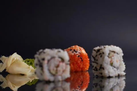 One roll in focus, a portion of rolls out of focus, Asian food, sushi and fish Stock Photos