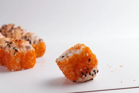One roll in focus, a portion of rolls out of focus, Asian food, sushi and fish Stock Photos