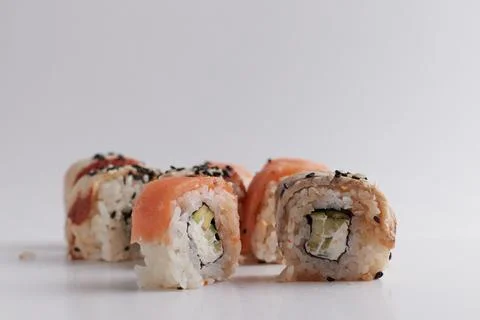 One roll in focus, a portion of rolls out of focus, Asian food, sushi and fish Stock Photos