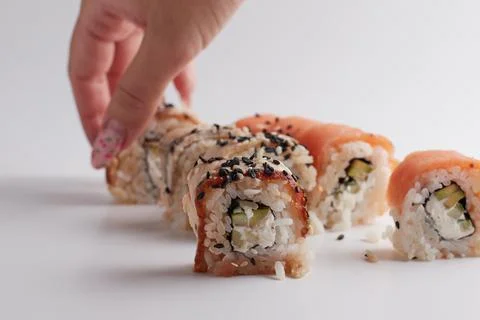 One roll in focus, a portion of rolls out of focus, Asian food, sushi and fish Stock Photos