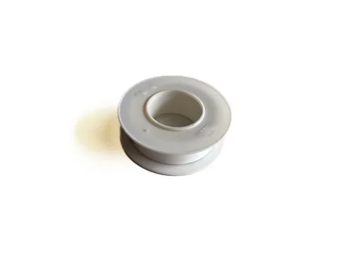 One roll of white thread seal tape Stock Photos