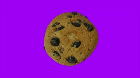 One round cookie rotating on changing background of dazzling colors. Stop motion Stock Footage 147042427