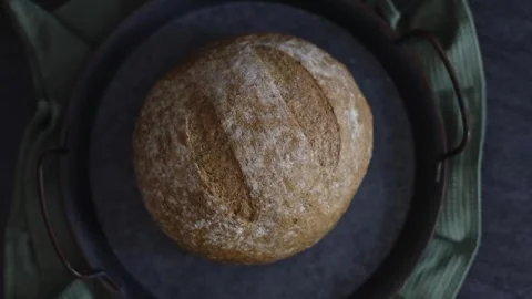 One rye bread in a vintage dish on a black stone background. Stock Footage 253590066