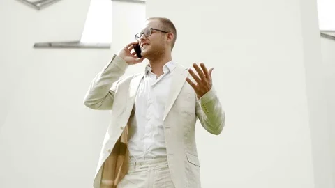 One sales man using smart phone talking about business wearing a white suit Stock Footage 72869206