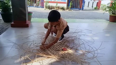 One Scout boy Elementary School Make a Handycraft from Rattan Stock Footage 201855690