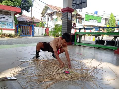 One Scout boy Elementary School Make a Handycraft from Rattan Stock Photos