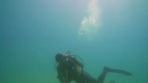 One Scuba Diver Goes With Garbage Bag Under the Sea Stock Footage 144835995