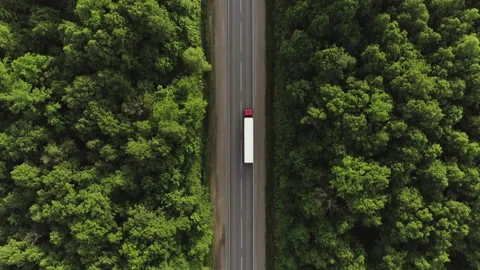 One Semi Truck with red trailer and cab driving / traveling alone Stock Footage